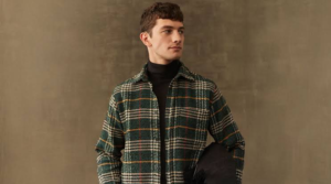 Man styling flannels over a hoodie with denim and trainers in 2026