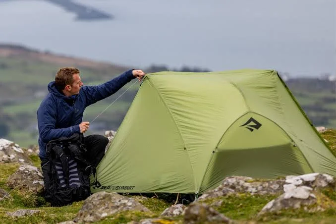 Two person tents pitched in a grassy UK campsite during a weekend trip